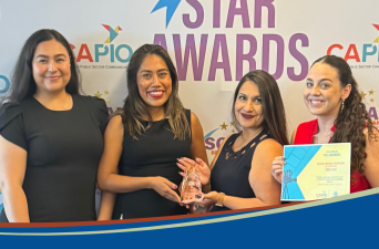 POGA Staff Members Pose with Award